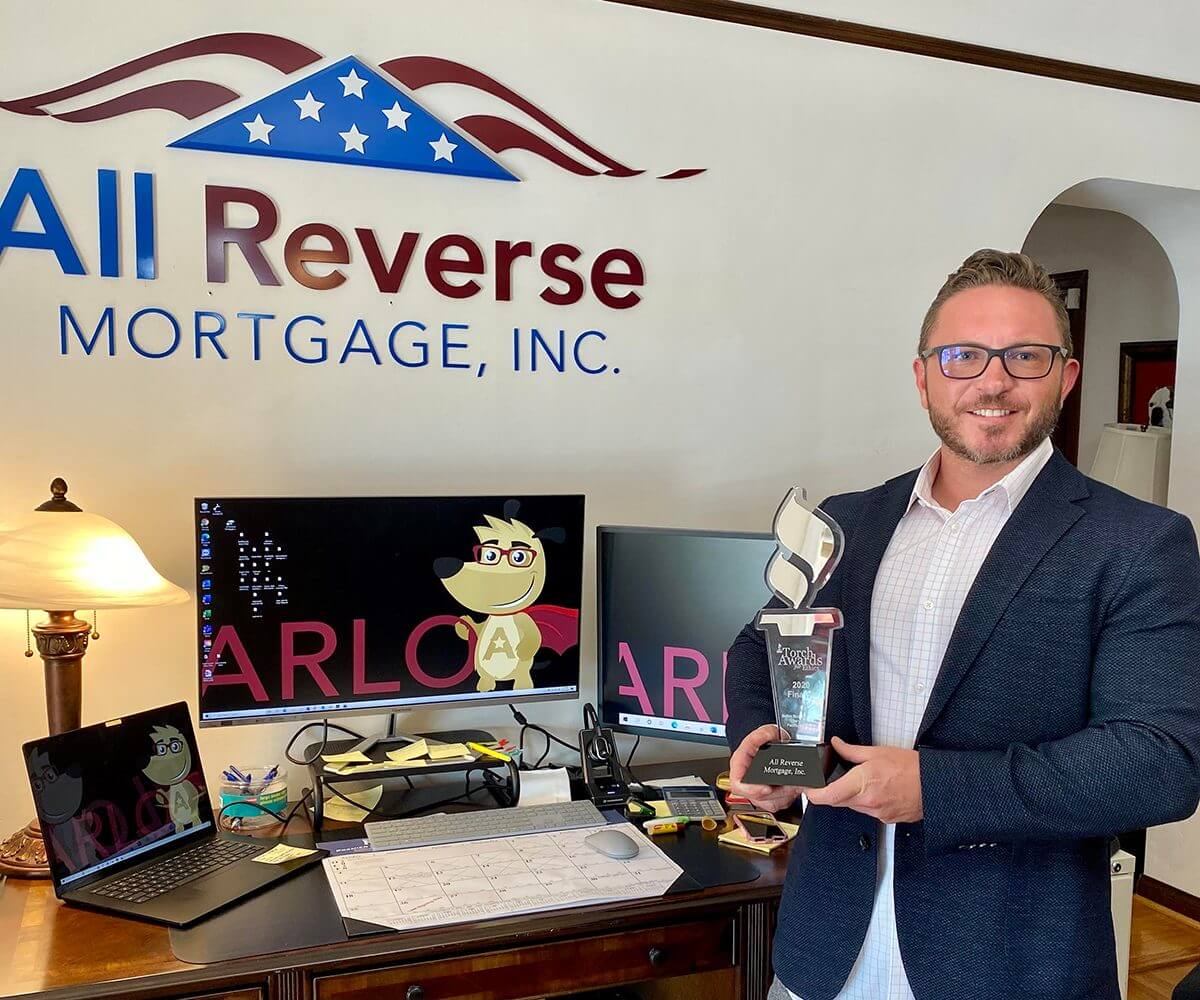 Cliff Auerswald holding BBB Torch Award for Ethics, All Reverse Mortgage Inc.